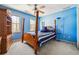 Blue bedroom featuring a wooden four-poster bed and built-in shelving at 3395 Hunters Place, Stonecrest, GA 30038