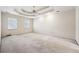 Spacious bedroom featuring tray ceiling with fan and plush carpeting at 3395 Hunters Place, Stonecrest, GA 30038