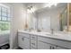 Modern bathroom features a double vanity with sleek fixtures and a glass-enclosed shower at 6023 Skellig St, Norcross, GA 30071