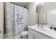 Modern bathroom featuring a stylish vanity, toilet, and a unique, decorative shower curtain at 6023 Skellig St, Norcross, GA 30071