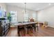 Dining room with wood floors, dark wood table and chairs, and lots of natural light at 6023 Skellig St, Norcross, GA 30071