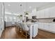A kitchen with white cabinets, granite countertops, an island with seating, and stainless steel appliances at 6023 Skellig St, Norcross, GA 30071
