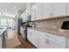 Bright kitchen featuring granite countertops, stainless steel appliances and views to the living room at 6023 Skellig St, Norcross, GA 30071
