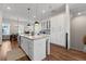 Kitchen featuring granite countertops, white cabinets, stainless steel appliances, and an island with seating at 6023 Skellig St, Norcross, GA 30071