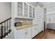 Kitchenette featuring granite countertops and white cabinets next to a staircase at 6023 Skellig St, Norcross, GA 30071