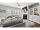 Inviting living room featuring hardwood floors, built-in bookshelves, fireplace and comfortable seating at 6023 Skellig St, Norcross, GA 30071