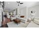 Modern open-concept living room with hardwood floors, fireplace, and kitchen view, perfect for entertaining at 6023 Skellig St, Norcross, GA 30071