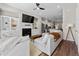 Bright open-concept living room with fireplace, hardwood floors, modern furniture, and stylish decor at 6023 Skellig St, Norcross, GA 30071