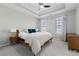 Bright main bedroom with a tray ceiling, two windows, and neutral décor at 6023 Skellig St, Norcross, GA 30071