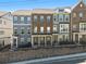 View of townhomes with modern architectural details, showcasing multi-story facade and appealing design at 6023 Skellig St, Norcross, GA 30071