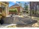 Beautiful backyard with stone terraces, lush lawn, mature trees, and ample seating at 840 Stonehaven Ln, Alpharetta, GA 30005