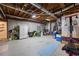 Unfinished basement featuring concrete floor, exposed ceiling, and workout equipment at 840 Stonehaven Ln, Alpharetta, GA 30005