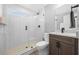 Bathroom with glass shower, dark vanity, and white wall tiles offering a clean and modern look at 840 Stonehaven Ln, Alpharetta, GA 30005