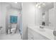 Bathroom featuring white vanity, toilet, tile floors, and shower with coordinated blue towels at 840 Stonehaven Ln, Alpharetta, GA 30005