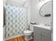 Bathroom with wood floors, patterned shower curtain and gray vanity sink at 840 Stonehaven Ln, Alpharetta, GA 30005