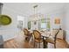 Dining room with wood table set for meal, view to entry and lots of natural light at 840 Stonehaven Ln, Alpharetta, GA 30005