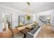Formal dining room with hardwood floors, decor, furniture and bright lighting at 840 Stonehaven Ln, Alpharetta, GA 30005
