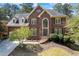 Charming two-story brick home featuring a beautifully landscaped front yard, arched windows and a classic design at 840 Stonehaven Ln, Alpharetta, GA 30005