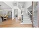 Bright foyer with hardwood floors, staircase with iron spindles, and view to the dining room at 840 Stonehaven Ln, Alpharetta, GA 30005