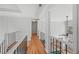 Bright hallway with hardwood floors, staircase, and black rails at 840 Stonehaven Ln, Alpharetta, GA 30005