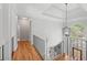 Bright hallway with hardwood floors, staircase, black rails, and a chandelier at 840 Stonehaven Ln, Alpharetta, GA 30005