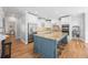 Island kitchen with granite countertops, white cabinets, and stainless steel appliances at 840 Stonehaven Ln, Alpharetta, GA 30005
