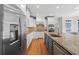 Spacious kitchen featuring stainless steel appliances, white cabinets, and a center island at 840 Stonehaven Ln, Alpharetta, GA 30005