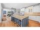 Bright kitchen island featuring stone countertops, an undermount sink, and seating at 840 Stonehaven Ln, Alpharetta, GA 30005