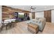 Open living room featuring hardwood floors, barn doors, and a modern media center for entertaining at 840 Stonehaven Ln, Alpharetta, GA 30005