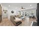 Spacious living room featuring hardwood floors, a ceiling fan, and a view of the stairwell at 840 Stonehaven Ln, Alpharetta, GA 30005