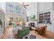 Bright living room with fireplace, bookshelves, hardwood floors and high ceilings at 840 Stonehaven Ln, Alpharetta, GA 30005