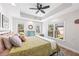 Bright main bedroom with tray ceilings and many windows offering natural light and outdoor views at 840 Stonehaven Ln, Alpharetta, GA 30005