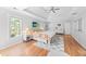 Spacious main bedroom with tray ceilings, windows, hardwood floors and ceiling fan at 840 Stonehaven Ln, Alpharetta, GA 30005
