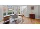 Office with large windows, L-shaped desk, hardwood floors, and stylish decor at 840 Stonehaven Ln, Alpharetta, GA 30005