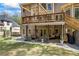 Covered patio with outdoor seating, a swing, ceiling fan, and view of the lush backyard at 840 Stonehaven Ln, Alpharetta, GA 30005