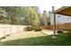 Expansive backyard features a stone patio, privacy fence, and lush green grass at 1924 Sweet Flag Rd, Lawrenceville, GA 30045