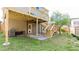 Spacious backyard featuring a well-maintained lawn, wooden deck with stairs and a covered patio area at 1924 Sweet Flag Rd, Lawrenceville, GA 30045