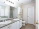 Bathroom with dual sinks, vanity, granite countertops, tile flooring, and soaking tub at 1924 Sweet Flag Rd, Lawrenceville, GA 30045
