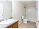 Well-lit bathroom with a tub, shower combination, and a wood vanity with granite countertop at 1924 Sweet Flag Rd, Lawrenceville, GA 30045
