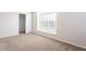 Bright bedroom with plush carpeting, large window, and closet with sliding doors at 1924 Sweet Flag Rd, Lawrenceville, GA 30045
