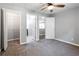 Spacious bedroom featuring neutral walls, plush carpet, ceiling fan, and a closet for ample storage space at 1924 Sweet Flag Rd, Lawrenceville, GA 30045