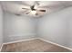 A bright bedroom is designed with a modern ceiling fan and soft neutral carpeting for a comfortable feel at 1924 Sweet Flag Rd, Lawrenceville, GA 30045