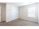 Bedroom with a large window, closet, neutral walls and carpet, creating a blank canvas at 1924 Sweet Flag Rd, Lawrenceville, GA 30045