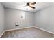Well-lit bedroom with neutral gray walls, plush carpet, and a window that offers natural light at 1924 Sweet Flag Rd, Lawrenceville, GA 30045