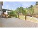 Large wooden deck with wooden railings overlooking a green and wooded yard at 1924 Sweet Flag Rd, Lawrenceville, GA 30045