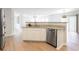 Open kitchen features stainless steel dishwasher, granite countertops and hardwood floors at 1924 Sweet Flag Rd, Lawrenceville, GA 30045