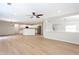 Open-concept living area with light wood floors, white kitchen with island, and ample natural light at 1924 Sweet Flag Rd, Lawrenceville, GA 30045