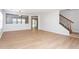Open-concept living area with light wood floors, staircase and neutral paint, creating a bright and spacious feel at 1924 Sweet Flag Rd, Lawrenceville, GA 30045
