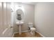 Bright powder room features a pedestal sink and a modern toilet at 1924 Sweet Flag Rd, Lawrenceville, GA 30045