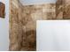 Tiled shower stall featuring stone-look tiles and a mosaic tile floor, offering a luxurious bathing experience at 1924 Sweet Flag Rd, Lawrenceville, GA 30045